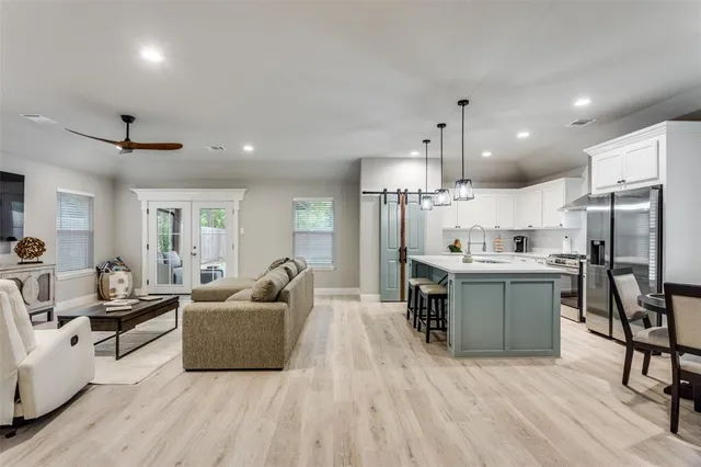 a living room with furniture and a wooden floor