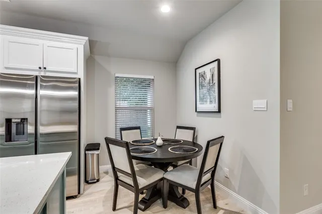 a view of a dining room with furniture and window