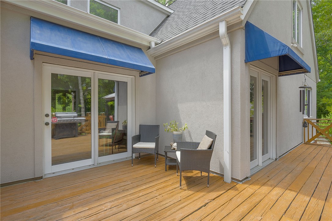 218 Northridge Drive Anderson, SC 29621 - Photo 37 of 50 A spacious wooden deck extends from the stucco exterior, offering a tranquil outdoor living space.
