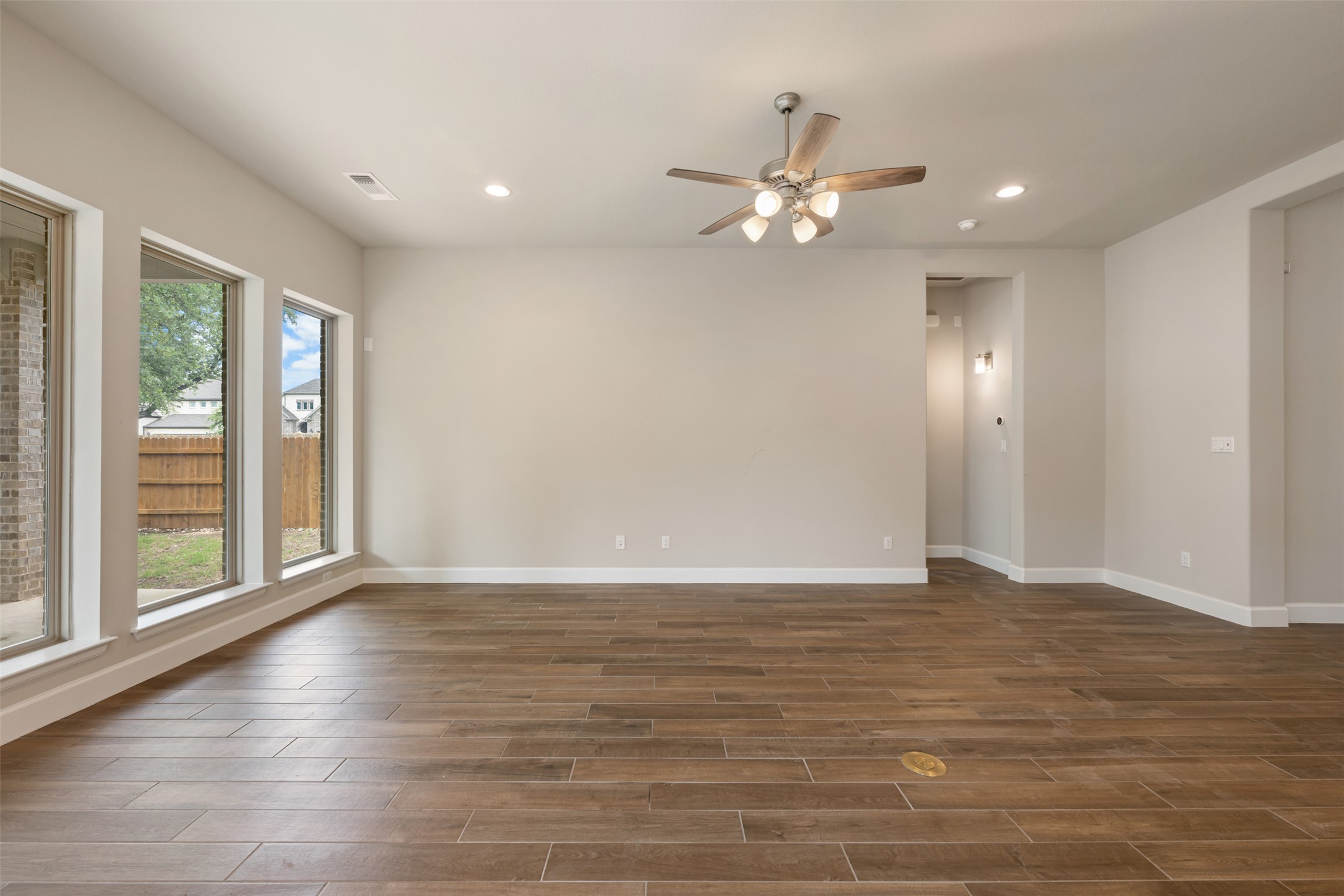 104 Anejo Bluff Georgetown, TX 78628 - Photo 22 of 40 a view of an empty room with wooden floor and a window