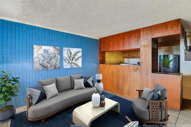 a living room with furniture and a potted plant