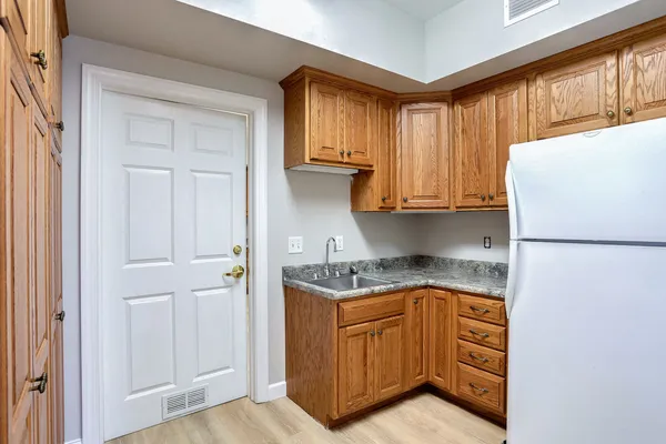 a kitchen with stainless steel appliances granite countertop a refrigerator and a stove