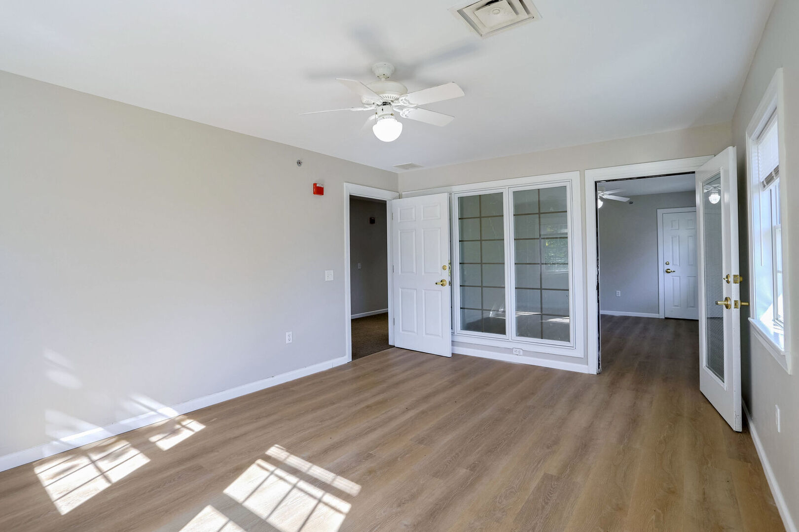 504 East Church Street Champaign, IL 61820 - Photo 24 of 55 a view of an empty room with wooden floor and a ceiling fan