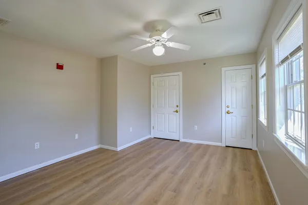 wooden floor in an empty room with a window