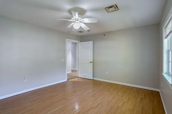 a view of an empty room with wooden floor