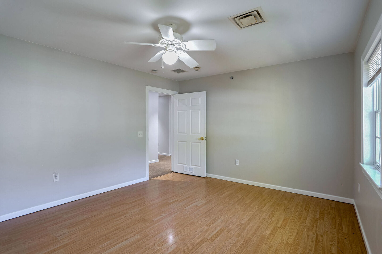 504 East Church Street Champaign, IL 61820 - Photo 33 of 55 an empty room with wooden floor and fan