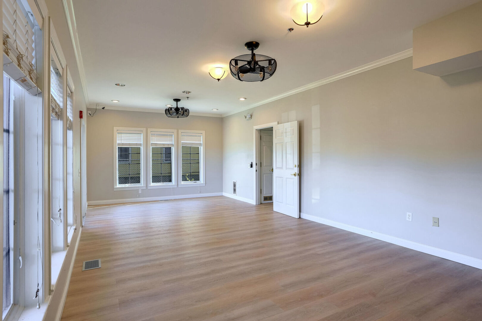 504 East Church Street Champaign, IL 61820 - Photo 10 of 55 a view of an empty room with a window and wooden floor