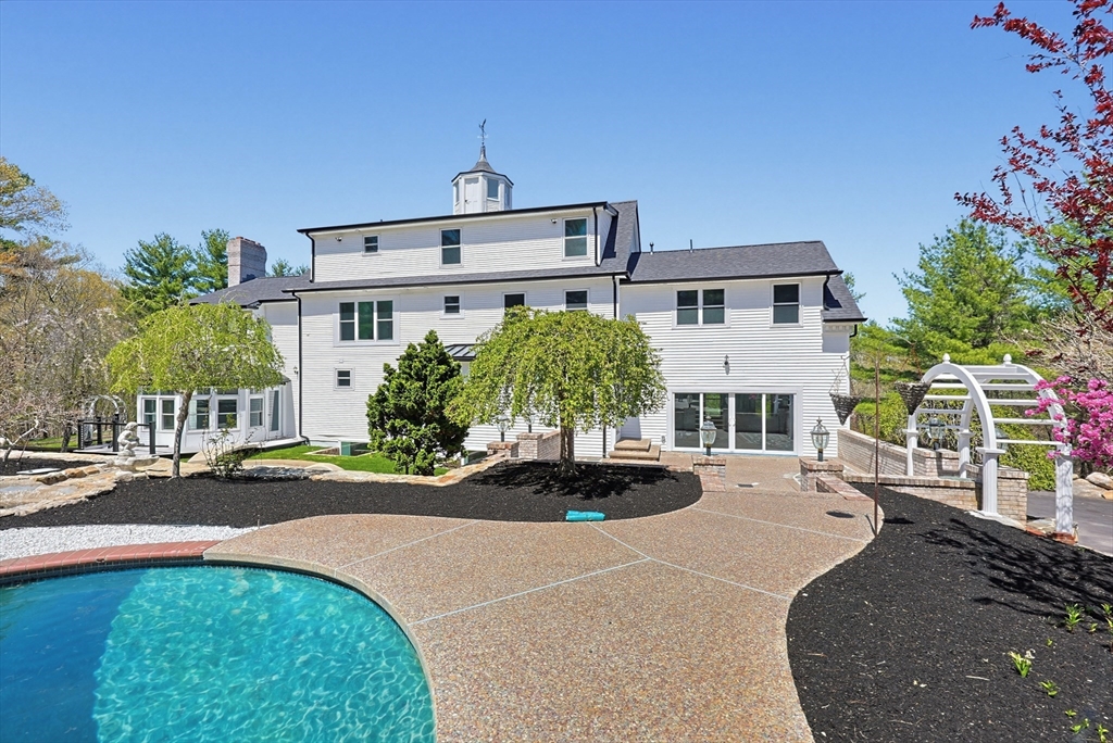 175 Pleasant Street Upton, MA 01568 - Photo 2 of 39 a front view of a house with a yard and potted plants