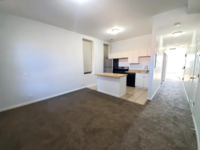 a view of kitchen with sink microwave and refrigerator
