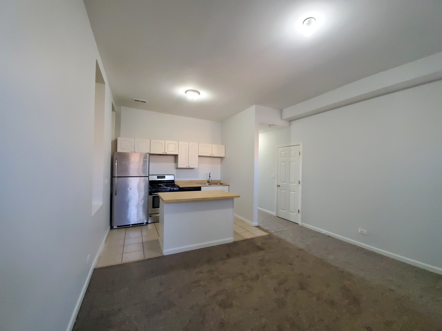 752 East 43rd Street, Unit 2E Chicago, IL 60653 - Photo 8 of 16 a kitchen with a sink stainless steel appliances and cabinets