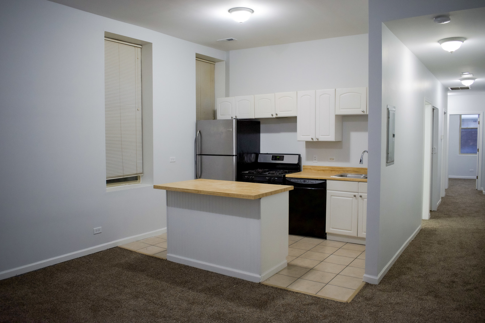 752 East 43rd Street, Unit 2E Chicago, IL 60653 - Photo 10 of 16 a kitchen with granite countertop a refrigerator stove top oven and sink