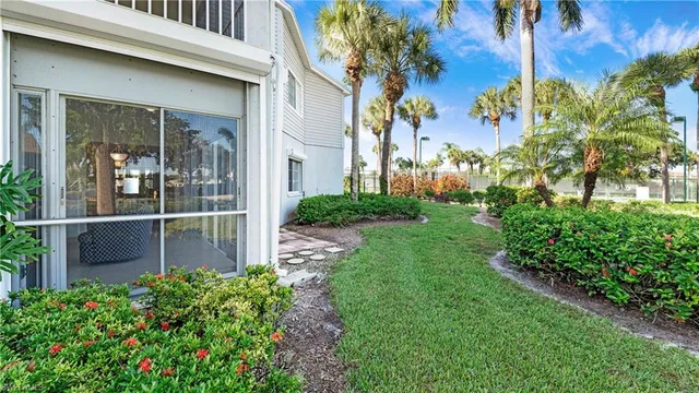 a view of a entrance gate of the house and trees
