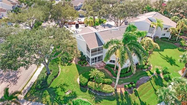 an aerial view of a house with a yard