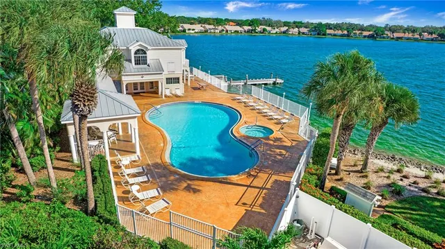 an aerial view of a house with outdoor space and lake view