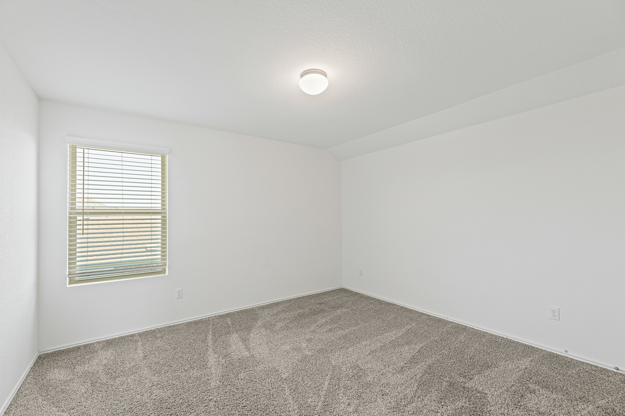 21317 Resource Road Pflugerville, TX 78660 - Photo 26 of 37 An inviting room features freshly cleaned carpeting and a single window with blinds.