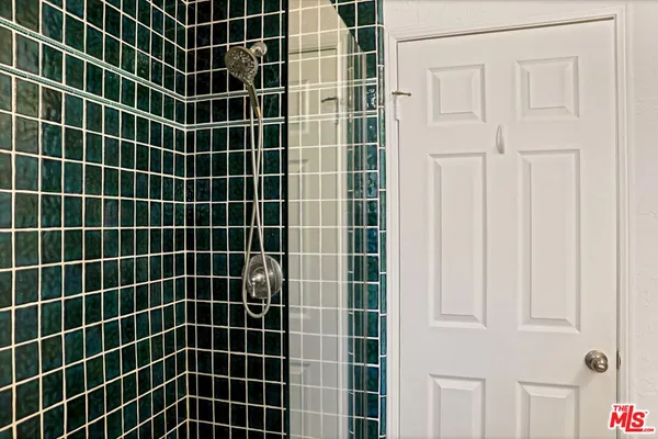 a bathroom with a sink a mirror and shower