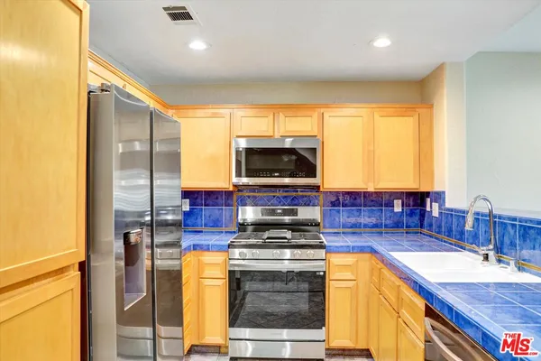 a kitchen with a stove and a sink