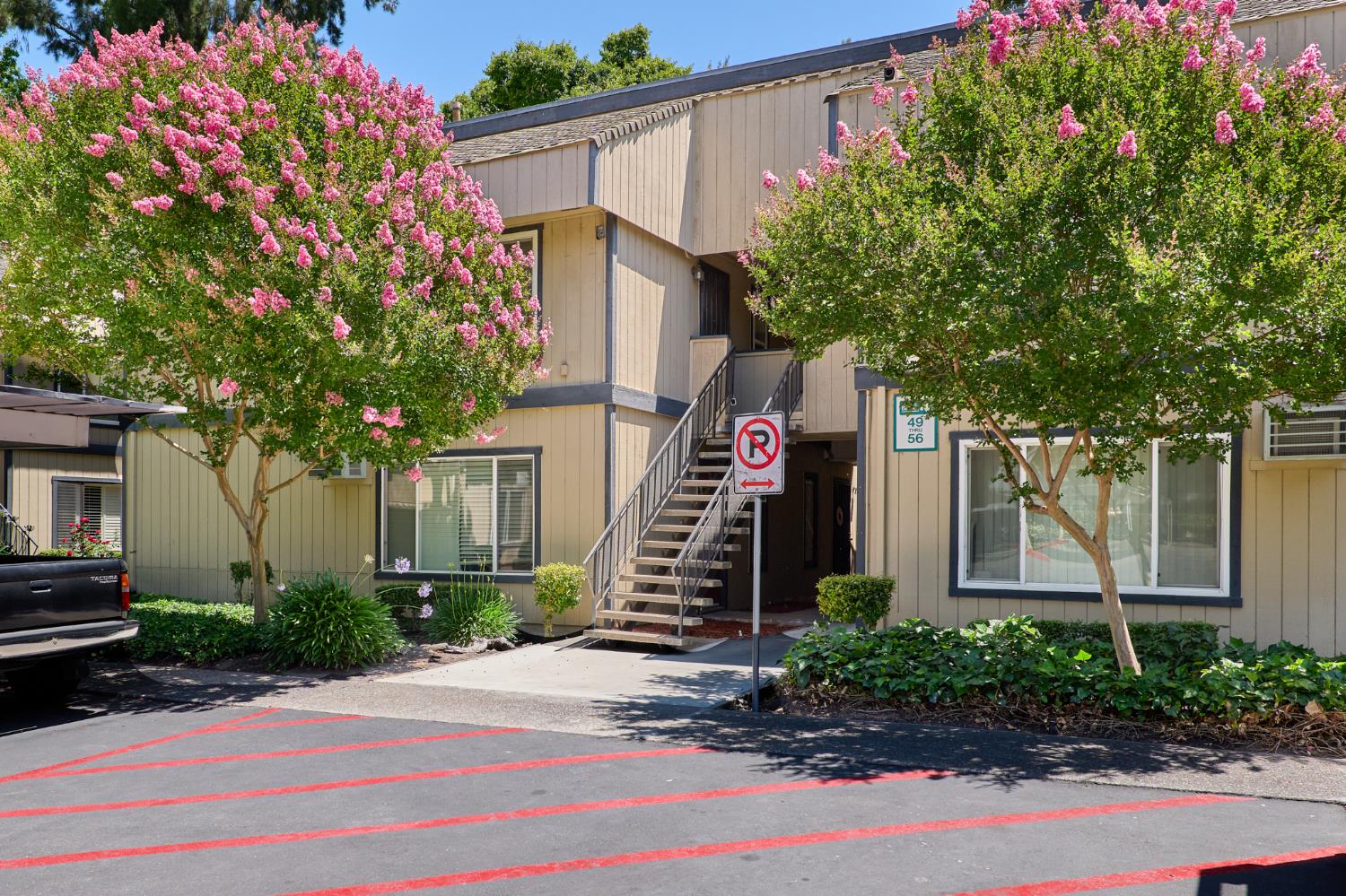 a front view of a house with a tree