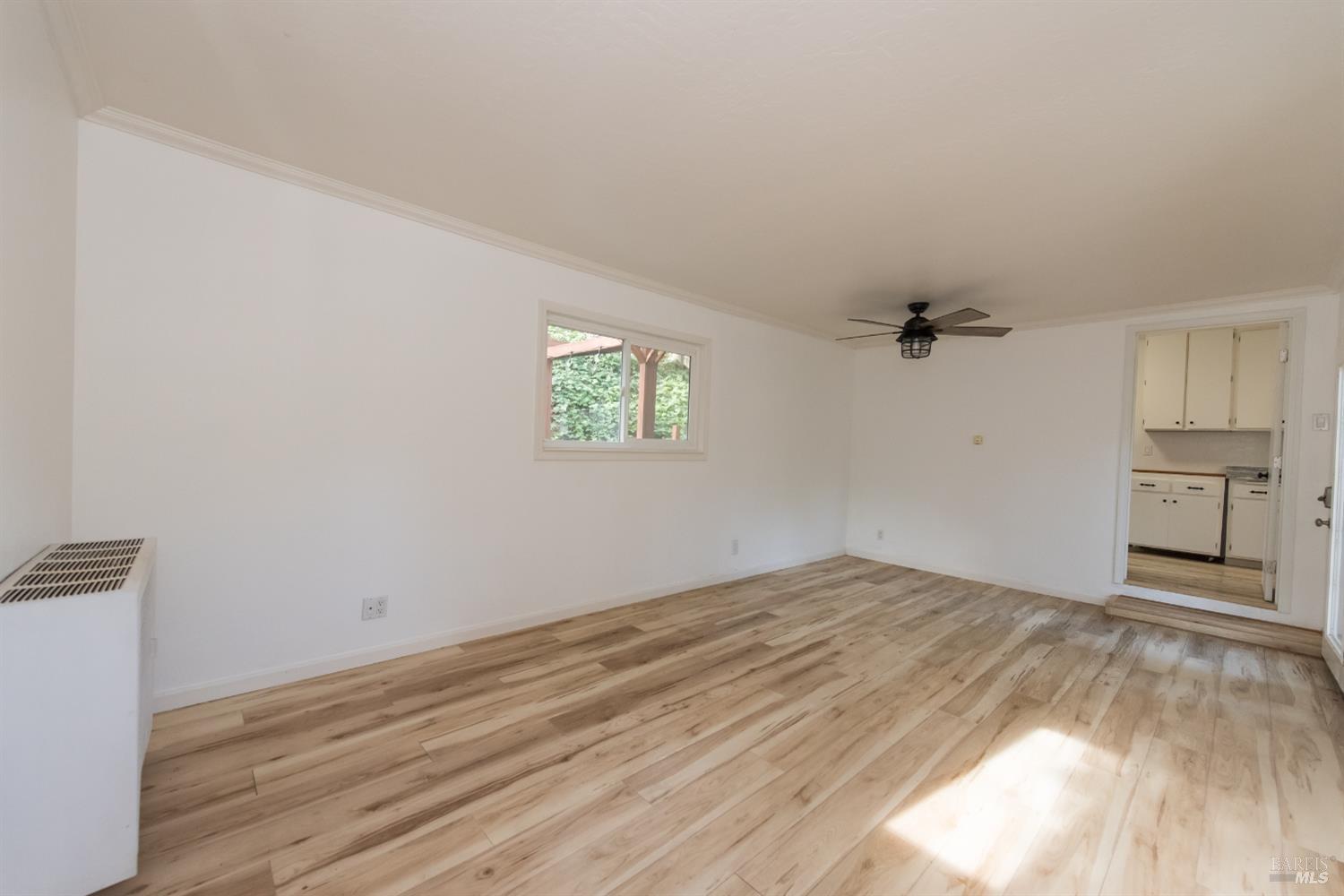 8650 Mirabel Road Forestville, CA 95436 - Photo 13 of 42 a view of empty room with wooden floor and fan