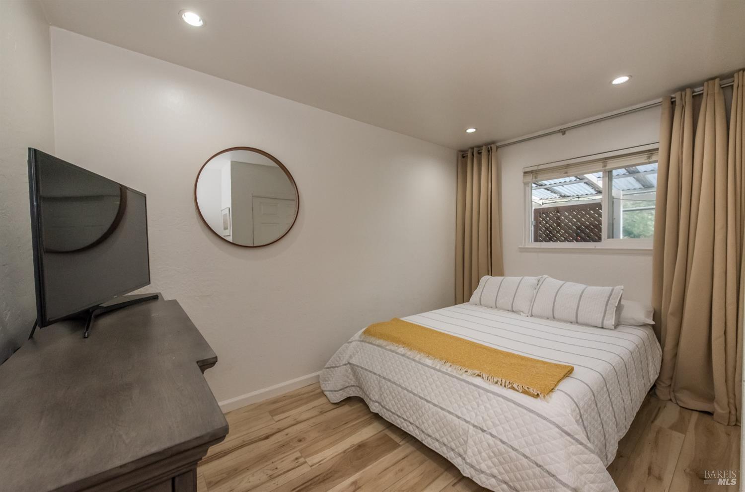 8650 Mirabel Road Forestville, CA 95436 - Photo 19 of 42 a bedroom with a bed and a chandelier