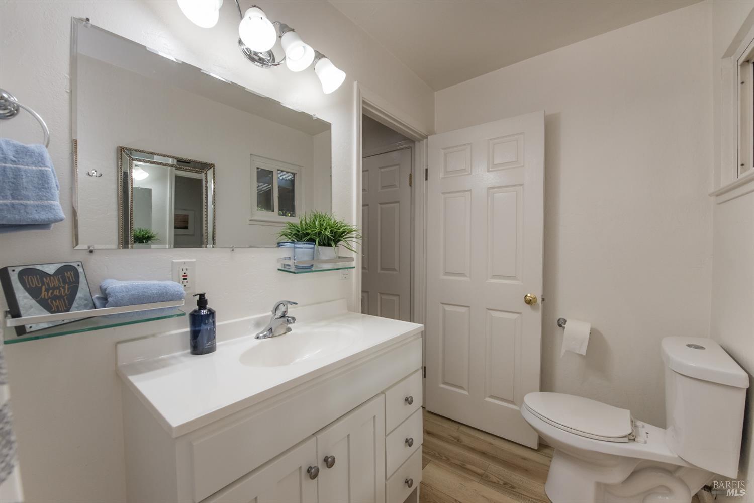 8650 Mirabel Road Forestville, CA 95436 - Photo 22 of 42 a bathroom with a toilet a sink a mirror and vanity