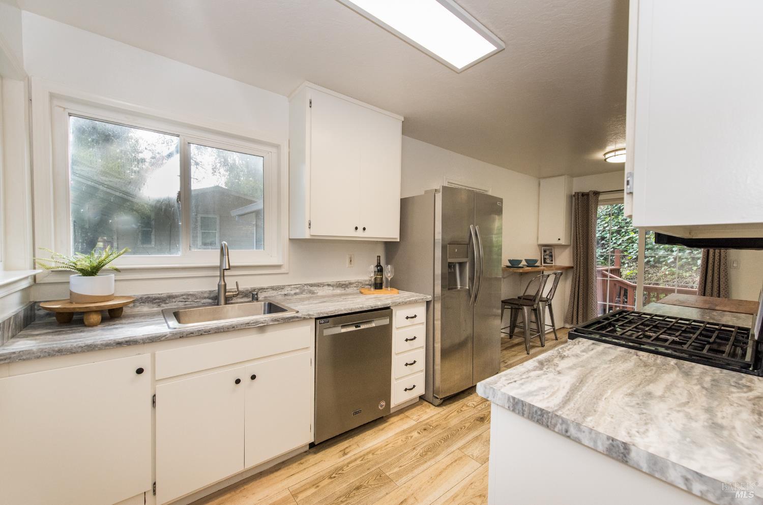 8650 Mirabel Road Forestville, CA 95436 - Photo 5 of 42 a kitchen with a sink stove and refrigerator