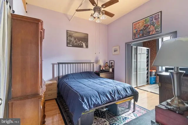 a bedroom with a bed and wooden floor