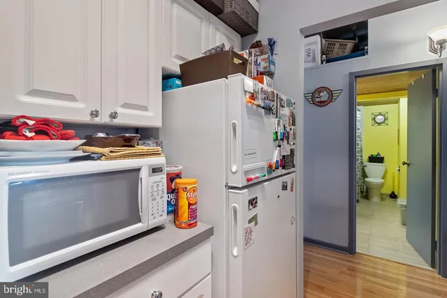 a utility room with fridge dryer and washer