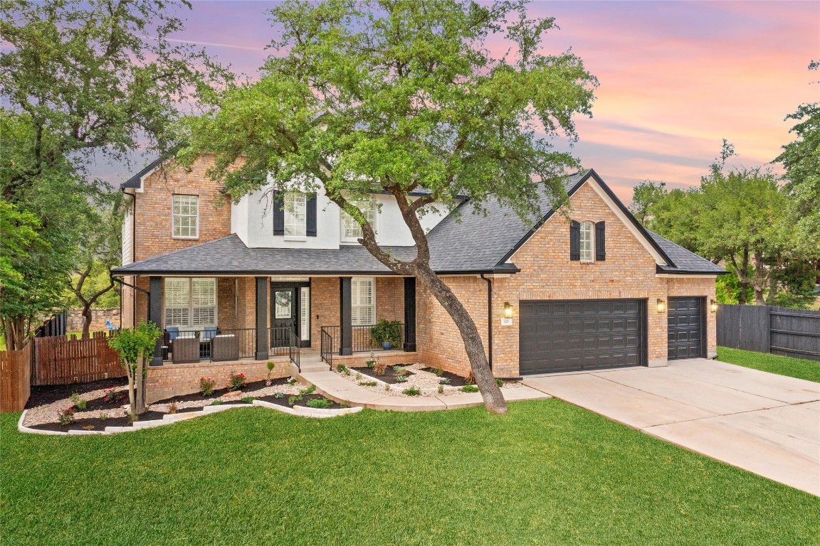 a front view of a house with a yard and porch