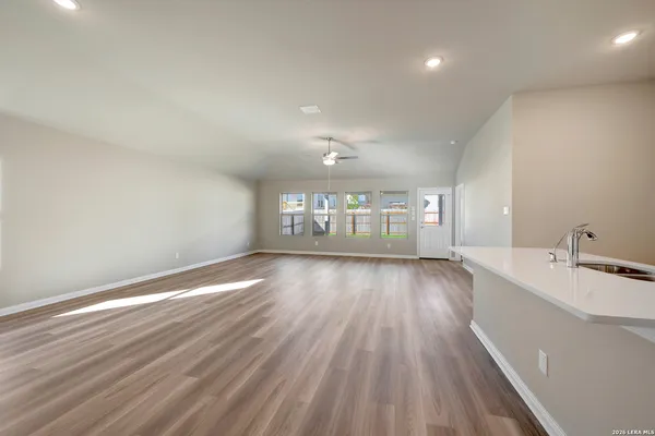 a view of a room with wooden floor and windows