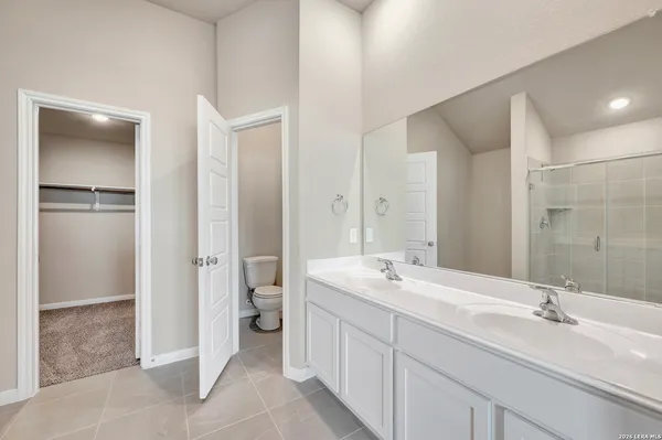 a spacious bathroom with a double vanity sink mirror and double
