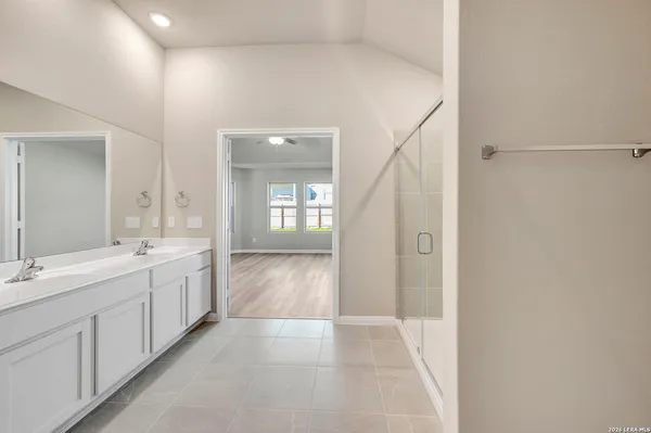 a spacious bathroom with a double vanity sink and mirror