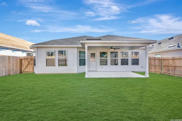 a view of a house with a backyard