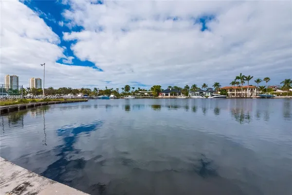 a view of a lake with houses in the back