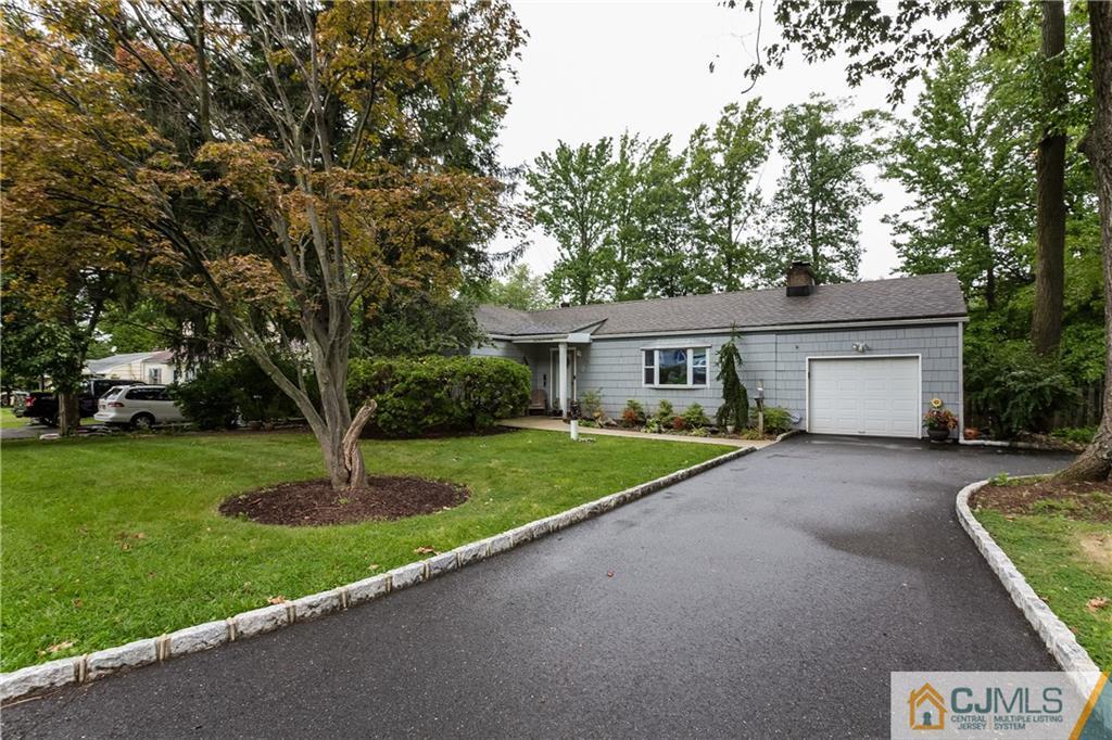190 Normandy Road Edison, NJ 08820 - Photo 1 of 25 a front view of a house with a garden and trees