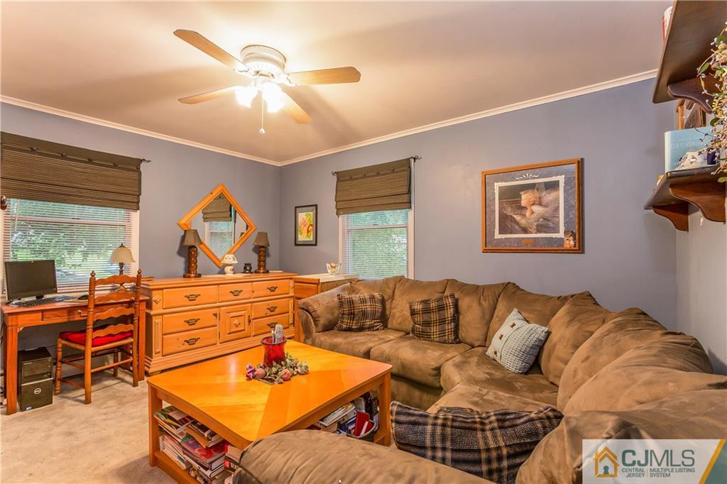 190 Normandy Road Edison, NJ 08820 - Photo 14 of 25 a living room with furniture a flat screen tv and a dresser