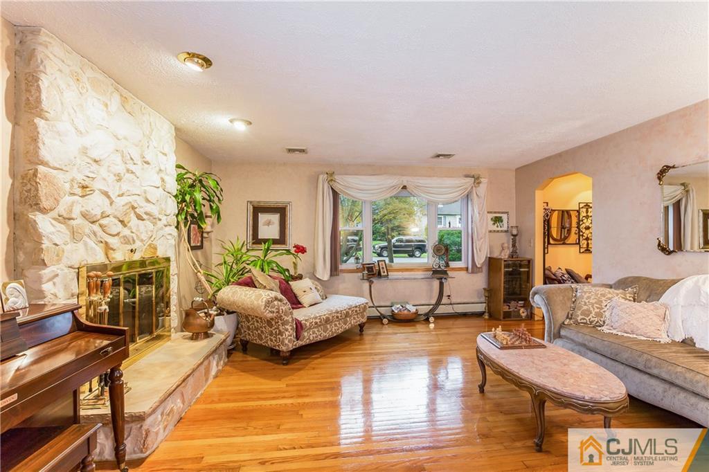 190 Normandy Road Edison, NJ 08820 - Photo 5 of 25 a living room with furniture and a fireplace
