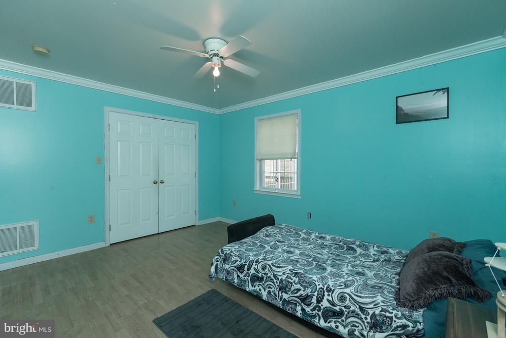 562 St Davids Church Road Fort Valley, VA 22652 - Photo 21 of 30 a bedroom with a bed and a chandelier fan