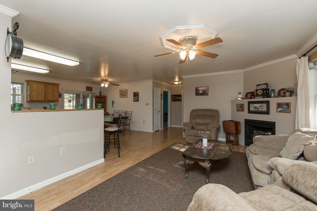 562 St Davids Church Road Fort Valley, VA 22652 - Photo 8 of 30 a living room with furniture kitchen view and a chandelier