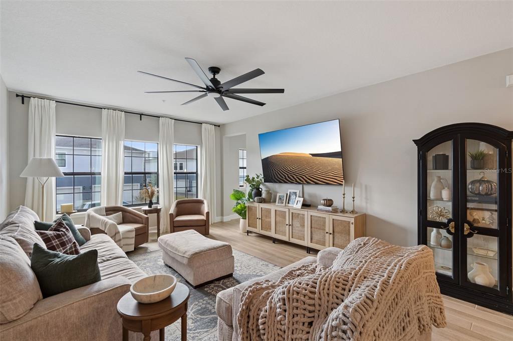 1230 Spotted Sandpiper Loop Winter Springs, FL 32708 - Photo 15 of 52 a living room with furniture a ceiling fan and a flat screen tv