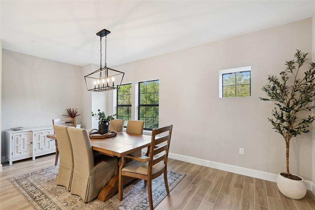 1230 Spotted Sandpiper Loop Winter Springs, FL 32708 - Photo 18 of 52 a dining room with furniture wooden floor and a chandelier