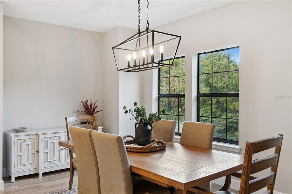 1230 Spotted Sandpiper Loop Winter Springs, FL 32708 - Photo 23 of 52 a view of a dining room with furniture window and wooden floor