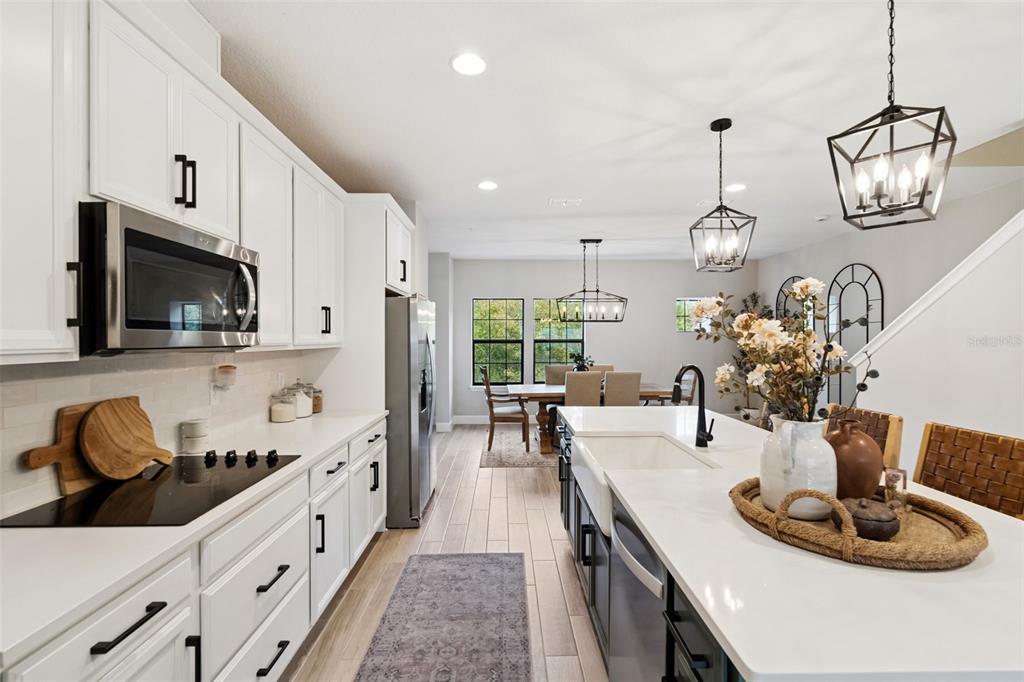 1230 Spotted Sandpiper Loop Winter Springs, FL 32708 - Photo 26 of 52 a kitchen with sink a microwave and living room view
