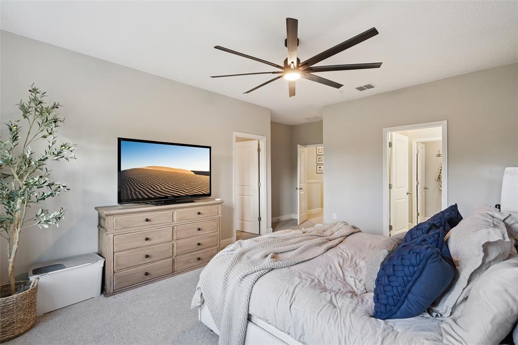 1230 Spotted Sandpiper Loop Winter Springs, FL 32708 - Photo 30 of 52 a bedroom with a bed and a flat screen tv