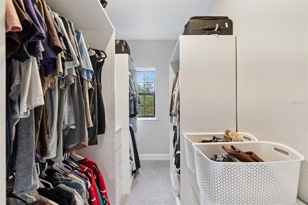 1230 Spotted Sandpiper Loop Winter Springs, FL 32708 - Photo 31 of 52 a view of walk in closet with clothes and shoes