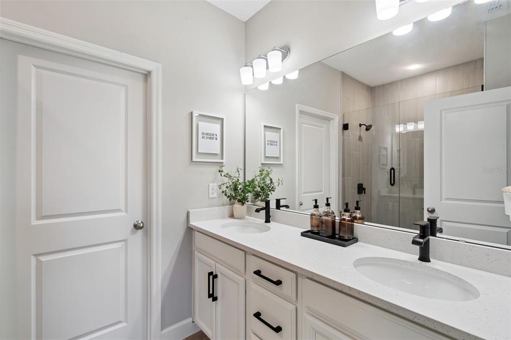 1230 Spotted Sandpiper Loop Winter Springs, FL 32708 - Photo 37 of 52 a bathroom with a sink a potted plant and a mirror