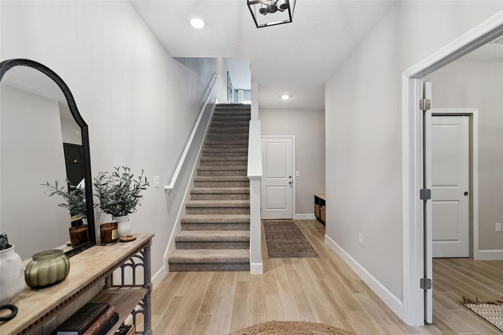 1230 Spotted Sandpiper Loop Winter Springs, FL 32708 - Photo 6 of 52 a view of a hallway with wooden floor and stairs