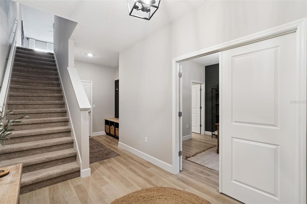 1230 Spotted Sandpiper Loop Winter Springs, FL 32708 - Photo 7 of 52 a view of a hallway with entryway and hall with wooden floor