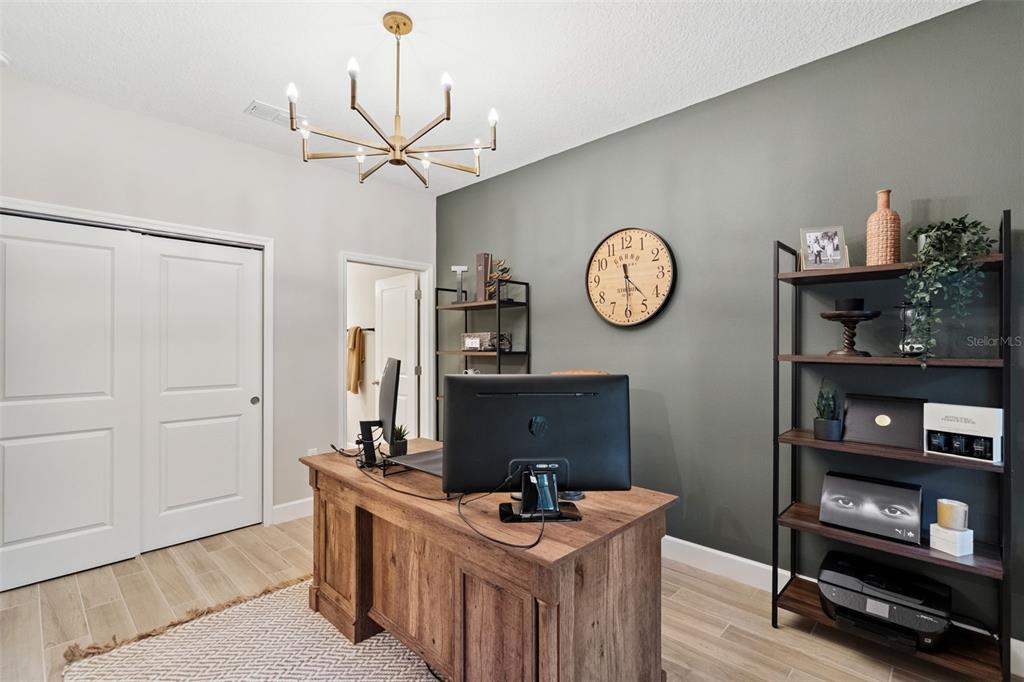 1230 Spotted Sandpiper Loop Winter Springs, FL 32708 - Photo 9 of 52 a view of a workspace with furniture and a clock