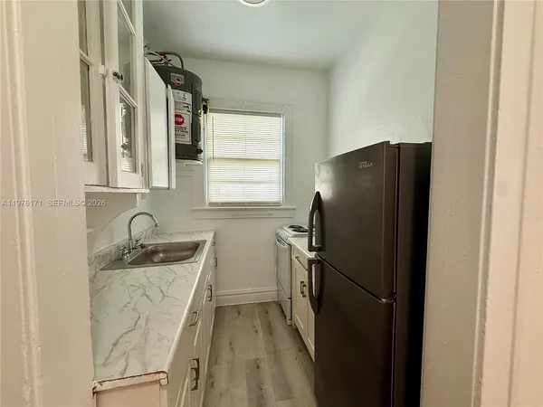 a kitchen with a refrigerator and a sink